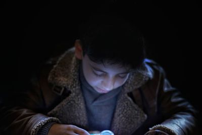 Close-up of boy using mobile phone