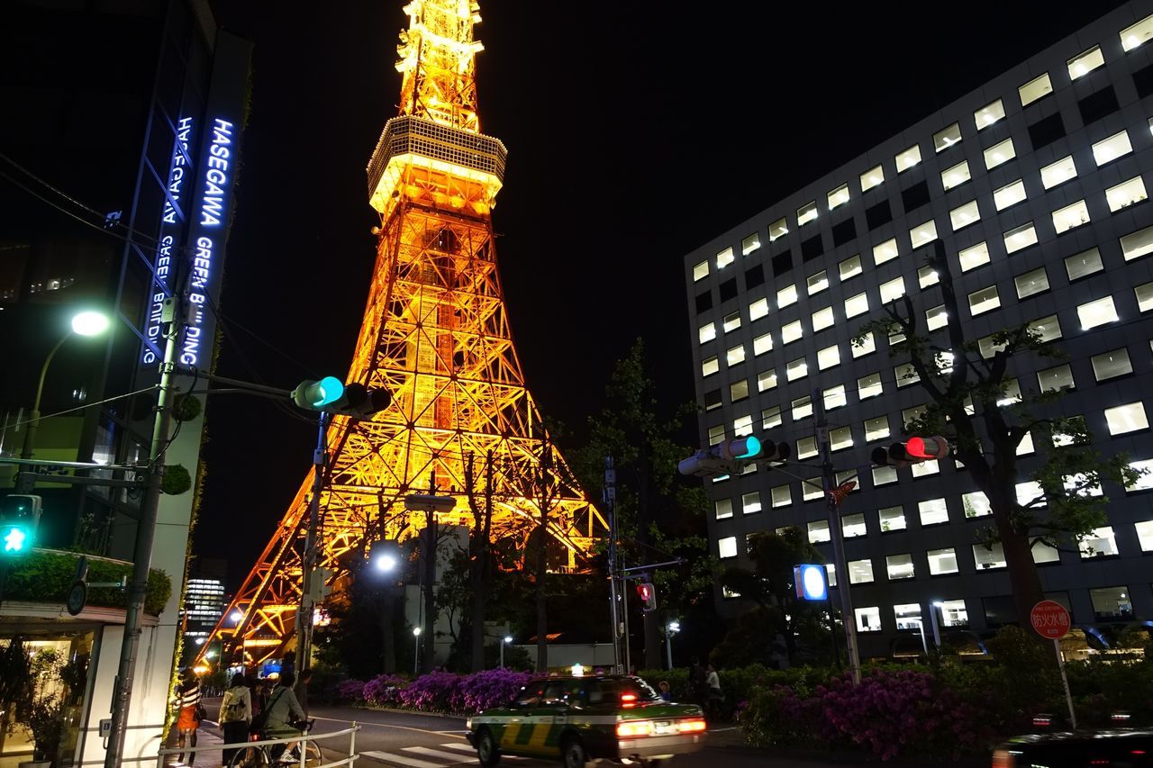 illuminated, building exterior, night, architecture, built structure, city, low angle view, tall - high, tower, city street, capital cities, street light, travel destinations, street, lighting equipment, city life, famous place, car, travel, sky