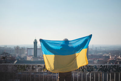Man with a ukrainian flag goes to join a demonstration in support of ukraine. support ukraine