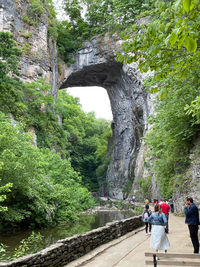 Rear view of people walking on rocks