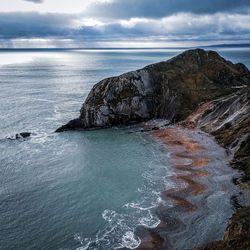 Rock formation on sea against sky