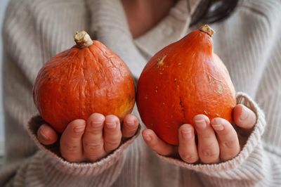 Close-up of woman holding pumpkin