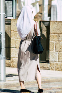 Rear view of women walking in city