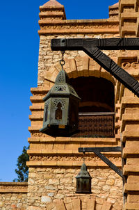 Low angle view of historic building against clear blue sky