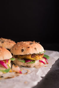 Close-up of burger against black background