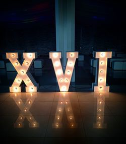 Digital composite image of illuminated lights on tiled floor