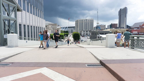 Buildings in city against cloudy sky