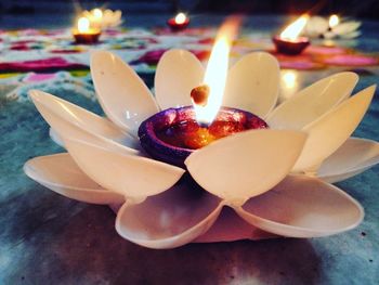 Close-up of illuminated candles on table