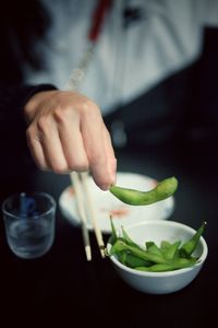 Midsection of man preparing food in bowl