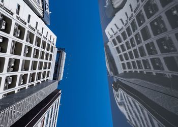 Low angle view of buildings against blue sky