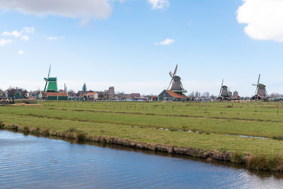 Traditional windmill on field against sky