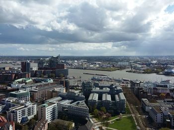 Cityscape against cloudy sky