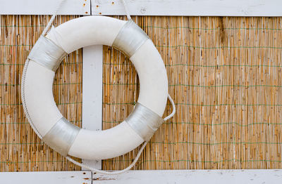 Close-up of white pipes hanging against wall