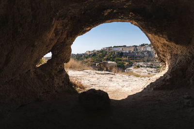View of rock formation seen through cave