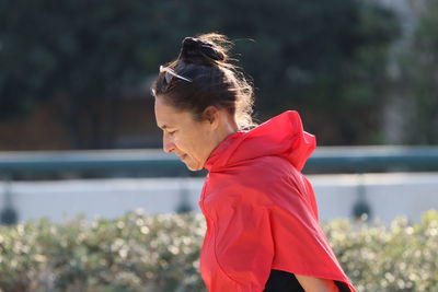 Side view of woman looking away outdoors