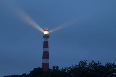 Low angle view of lighthouse against sky at night