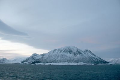 Scenic view of sea and mountains against sky