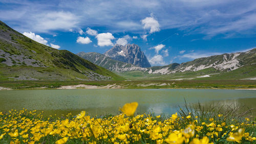 Scenic view of sea and mountains against sky