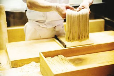 Man holding fresh spaghetti in hands