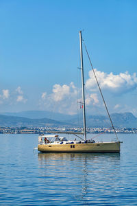 Sailboat sailing on sea against blue sky