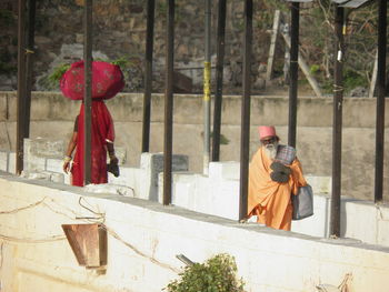 Rear view of man on cross against temple