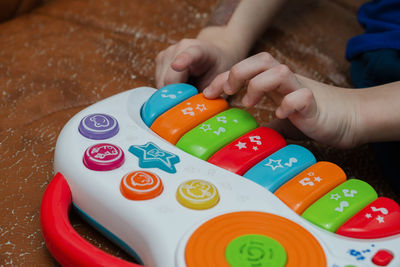 Midsection of child playing with ball on table