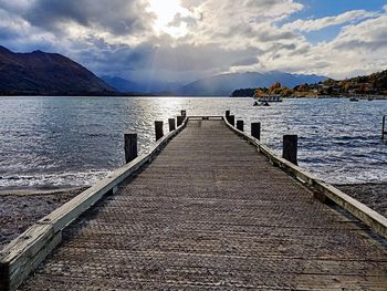 Pier over lake against sky