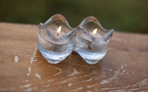 High angle view of burning candle on table