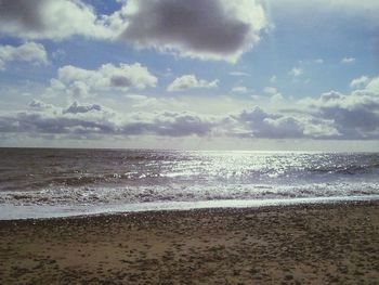 Scenic view of sea against cloudy sky