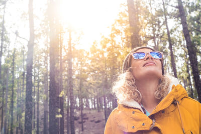 Young woman looking away in forest