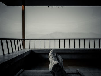 Low section of man relaxing on staircase