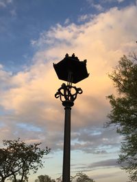 Low angle view of silhouette street light against sky