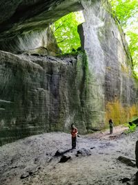 Rear view of man standing in cave