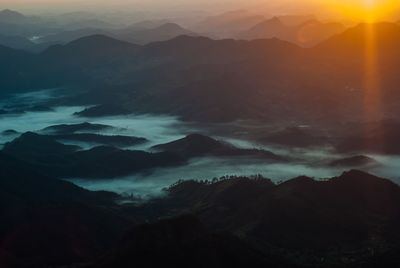 Scenic view of silhouette mountains against sky during sunset