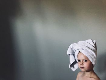 Portrait of cute boy against wall