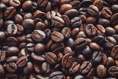 Coffee beans background, dark and light brown roasted coffee-beans closeup