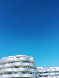 Low angle view of building against clear blue sky