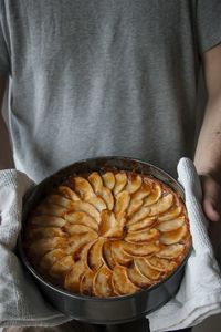 Midsection of man holding apple pie