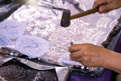 Cropped hand of woman working at workshop