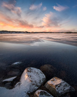 Scenic view of lake against sky during sunset