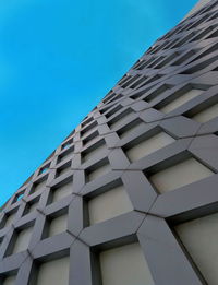 Low angle view of modern building against clear blue sky