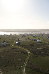 High angle view of landscape and sea against clear sky