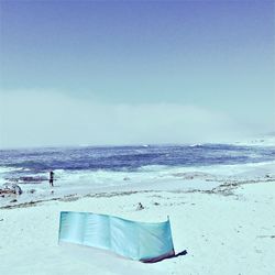 Scenic view of beach against blue sky