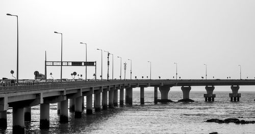 Bridge over sea against clear sky