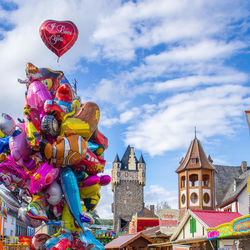 Colored air balloons for sale by street market stalls