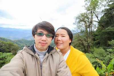 Portrait of smiling couple standing on mountain