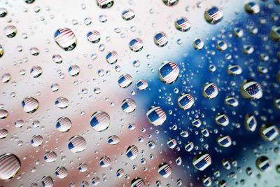 American flag reflecting in drops on glass