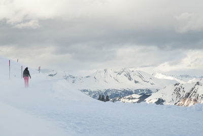 Scenic view of snowcapped mountains against cloudy sky