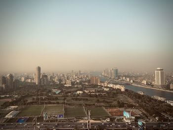 High angle view of buildings in city against clear sky