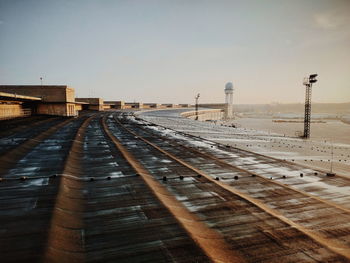 View of airport runway against sky during sunset